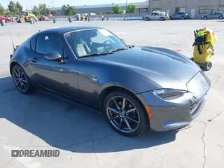 2019 Mazda MX-5 Miata Grand Touring z VIN JM1NDAM77K0310253, wystawiony jako IAAI lot #42406030 z przebiegiem 61 486 mil mil oraz . Historia ofert i sprzedaży dostępna na DreamBid. Obrazek 1.