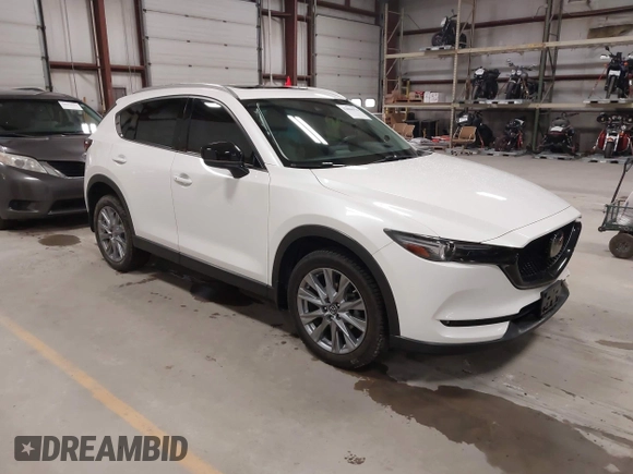 2020 Mazda CX-5 Grand Touring with VIN JM3KFBDM6L1828611, listed as a IAAI auction lot 42006976 with 59,939 mi miles and . Bid and sale history available at DreamBid. Image 1.