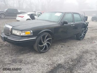 1997 Lincoln Town Car Signature with VIN 1LNLM82W4VY630979, listed as a IAAI auction lot 41775990 with 1 mi miles. Bid and sale history available at carsss.com. Image 2.