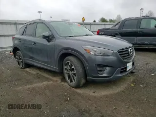 2016 Mazda CX-5 Grand Touring z VIN JM3KE2DY9G0687261, wystawiony jako Copart lot #52865415 z przebiegiem Nie podano mil oraz Szkoda całkowita • Salvage title. Historia ofert i sprzedaży dostępna na DreamBid. Obrazek 12.