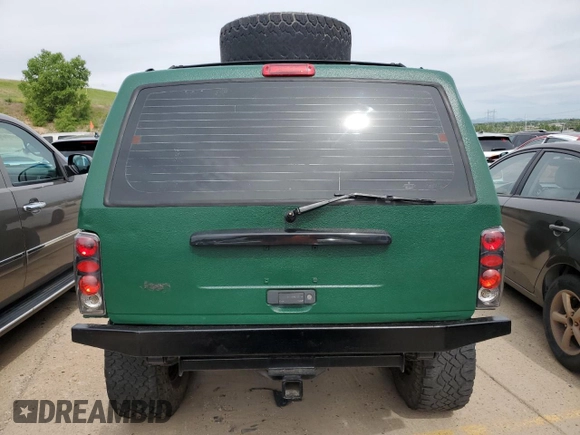1998 Jeep Cherokee Sport with VIN 1J4FJ68SXWL210381, listed as a Copart auction lot 58398995 with 211,870 mi miles and Salvage title. Bid and sale history available at DreamBid. Image 6.