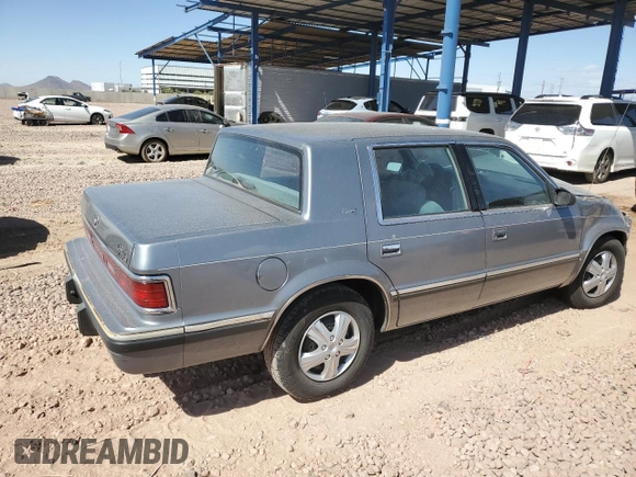 1991 Dodge Dynasty LE z VIN 1B3XC56R9MD115785, wystawiony jako Copart lot #48073715 z przebiegiem 64 483 mil mil oraz Szkoda całkowita • Salvage title. Historia ofert i sprzedaży dostępna na DreamBid. Obrazek 3.