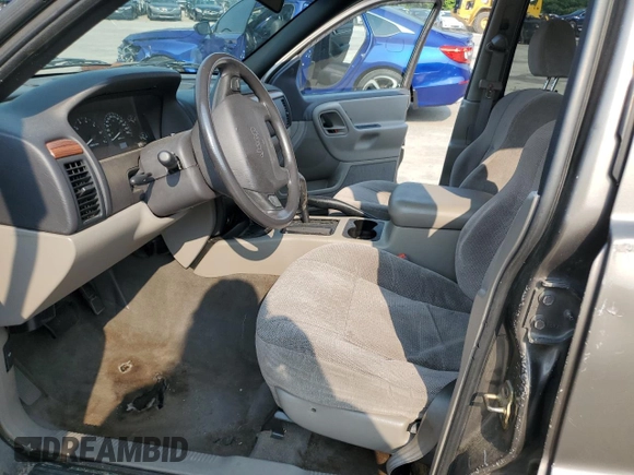 1999 Jeep Grand Cherokee Laredo with VIN 1J4G258S9XC731752, listed as a Copart auction lot 58601555 with 245,284 mi miles and Salvage title. Bid and sale history available at DreamBid. Image 7.