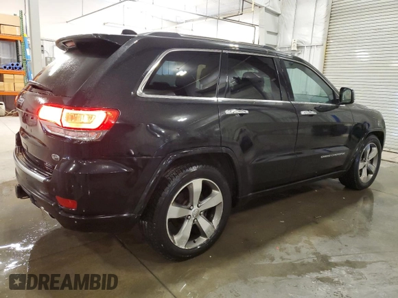2015 Jeep Grand Cherokee Overland with VIN 1C4RJFCG7FC911899, listed as a Copart auction lot 54123925 with 243,031 mi miles and Salvage Title. Bid and sale history available at carsss.com. Image 3.