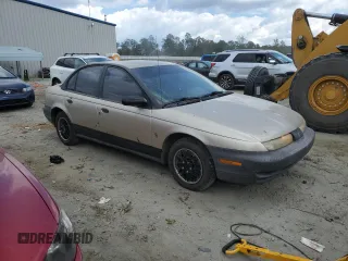 1999 Saturn SL z VIN 1G8ZH5280XZ178863, wystawiony jako Copart lot #73660474 z przebiegiem 195 738 mil mil oraz Szkody całkowita. Historia ofert i sprzedaży dostępna na DreamBid. Obrazek 4.