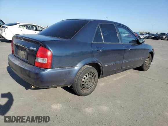1999 Mazda Protege DX z VIN JM1BJ2227X0106522, wystawiony jako Copart lot #52423565 z przebiegiem 206 260 mil mil oraz Szkoda całkowita • Salvage title. Historia ofert i sprzedaży dostępna na DreamBid. Obrazek 3.