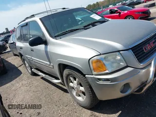 2004 GMC Envoy SLE with VIN 1GKDT13S042113411, listed as a IAAI auction lot 42117824 with 116,827 mi miles. Bid and sale history available at carsss.com. Image 1.