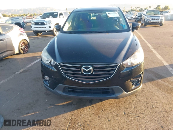 2016 Mazda CX-5 Touring with VIN JM3KE2CY5G0704574, listed as a IAAI auction lot 41033546 with 133,502 mi miles. Bid and sale history available at carsss.com. Image 12.