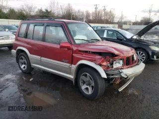 1996 Suzuki Sidekick z VIN JS3TD21V2T4103586, wystawiony jako Copart lot #83492154 z przebiegiem 98 298 mil mil oraz Szkody całkowita. Historia ofert i sprzedaży dostępna na DreamBid. Obrazek 4.