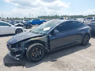 2023 Tesla Model 3 with VIN 5YJ3E1EAXPF575448, listed as a IAAI auction lot 42019288 with 33,859 mi miles and . Bid and sale history available at carsss.com. Image 2.