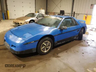 1987 Pontiac Fiero z VIN 1G2PF11R6HP237261, wystawiony jako Copart lot #85061534 z przebiegiem Nie podano mil oraz Czysty tytuł • Clean title. Historia ofert i sprzedaży dostępna na DreamBid. Obrazek 1.