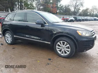 2014 Volkswagen Touareg Sport with VIN WVGEF9BP9ED011612, listed as a IAAI auction lot 41134643 with 131,034 mi miles and . Bid and sale history available at DreamBid. Image 1.