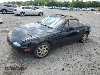 1996 Mazda MX-5 Miata z VIN JM1NA3537T0717894, wystawiony jako Copart lot #59794495 z przebiegiem 7 861 mil mil oraz Czysty tytuł • Clean title. Historia ofert i sprzedaży dostępna na DreamBid. Obrazek 1.