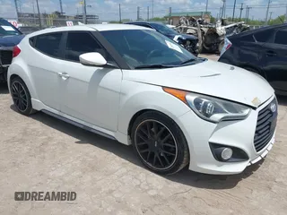 2014 Hyundai Veloster Turbo z VIN KMHTC6AE9EU188997, wystawiony jako IAAI lot #42845563 z przebiegiem 125 248 mil mil oraz . Historia ofert i sprzedaży dostępna na DreamBid. Obrazek 1.