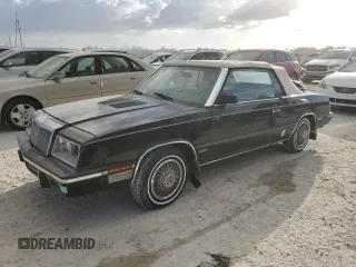 1985 Chrysler LeBaron Mark Cross z VIN 1C3BC55E0FG160918, wystawiony jako Copart lot #76659284 z przebiegiem Nie podano mil oraz Szkody całkowita. Historia ofert i sprzedaży dostępna na DreamBid. Obrazek 1.