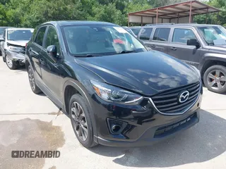 2016 Mazda CX-5 Grand Touring z VIN JM3KE2DY2G0765444, wystawiony jako IAAI lot #42527577 z przebiegiem 162 871 mil mil oraz . Historia ofert i sprzedaży dostępna na DreamBid. Obrazek 1.
