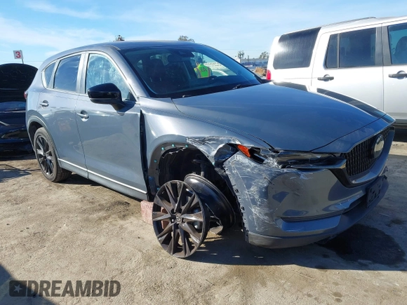 2021 Mazda CX-5 Touring with VIN JM3KFBCM9M0434433, listed as a IAAI auction lot 41425112 with 57,527 mi miles. Bid and sale history available at carsss.com. Image 1.