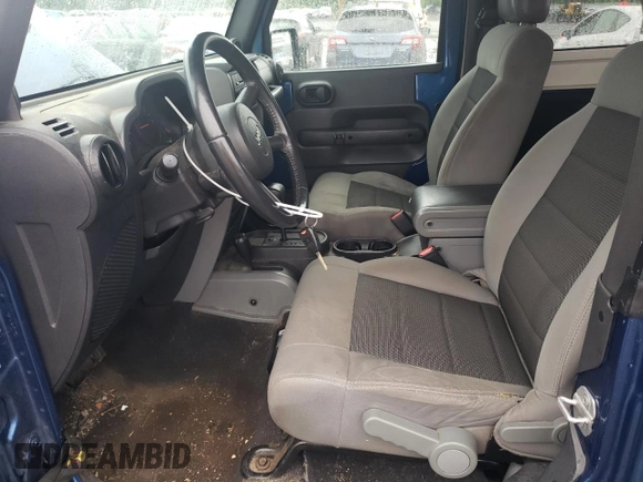 2009 Jeep Wrangler X with VIN 1J4FA24109L712701, listed as a Copart auction lot 60800855 with 156,709 mi miles and Salvage title. Bid and sale history available at DreamBid. Image 7.