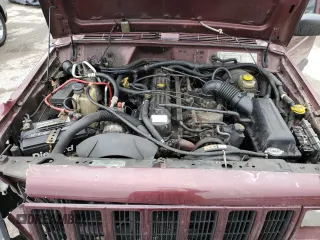 2000 Jeep Cherokee z VIN 1J4FF48S0YL254270, wystawiony jako Copart lot #52589415 z przebiegiem 166 860 mil mil oraz Szkoda całkowita • Salvage title. Historia ofert i sprzedaży dostępna na DreamBid. Obrazek 13.