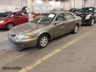 1999 Mazda 626 ES with VIN 1YVGF22C1X5852798, listed as a IAAI auction lot 41736489 with 136,536 mi miles. Bid and sale history available at carsss.com. Image 2.