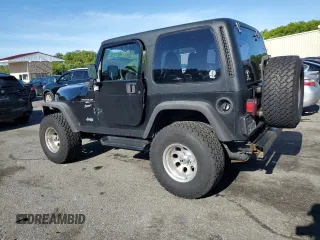 2001 Jeep Wrangler Sport with VIN 1J4FA49S21P339042, listed as a Copart auction lot 56922555 with 113,315 mi miles and Salvage title. Bid and sale history available at DreamBid. Image 2.