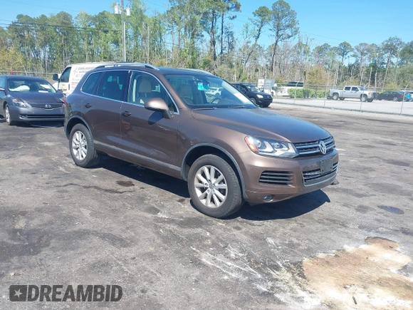 2014 Volkswagen Touareg Sport with VIN WVGEF9BP7ED003525, listed as a IAAI auction lot 41868307 with 74,379 mi miles and . Bid and sale history available at DreamBid. Image 1.