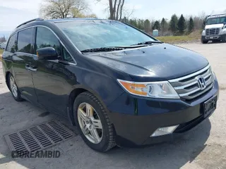 2011 Honda Odyssey Touring with VIN 5FNRL5H94BB027995, listed as a IAAI auction lot 42039709 with 225,439 mi miles and . Bid and sale history available at DreamBid. Image 1.