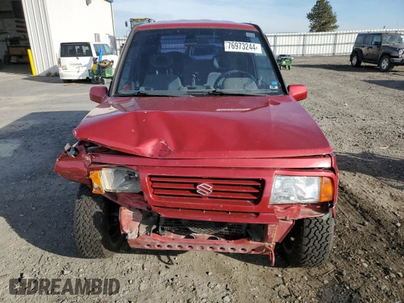 1995 Suzuki Sidekick z VIN JS3TD03V6S4113425, wystawiony jako Copart lot #76973244 z przebiegiem 152 638 mil mil oraz Szkody całkowita. Historia ofert i sprzedaży dostępna na DreamBid. Obrazek 5.