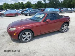 2007 Mazda MX-5 Miata Sport z VIN JM1NC25F570123843, wystawiony jako Copart lot #54828665 z przebiegiem 91 257 mil mil oraz Szkody całkowita. Historia ofert i sprzedaży dostępna na DreamBid. Obrazek 1.
