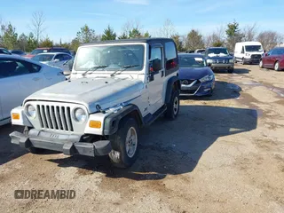 2004 Jeep Wrangler Sport Right Hand Drive with VIN 1J4F449SX4P780560, listed as a IAAI auction lot 41645721 with 146,681 mi miles. Bid and sale history available at carsss.com. Image 2.
