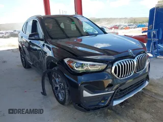 2021 BMW X1 sDrive28i with VIN WBXJG7C02M5S59010, listed as a IAAI auction lot 41933532 with 49,207 mi miles. Bid and sale history available at carsss.com. Image 1.