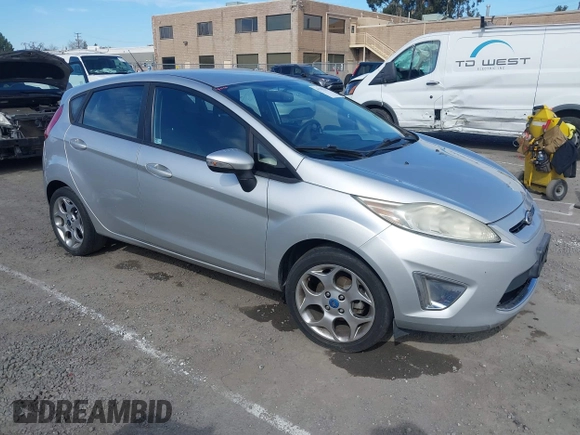 2011 Ford Fiesta SES with VIN 3FADP4FJ1BM102434, listed as a IAAI auction lot 41703287 with 124,476 mi miles. Bid and sale history available at carsss.com. Image 1.
