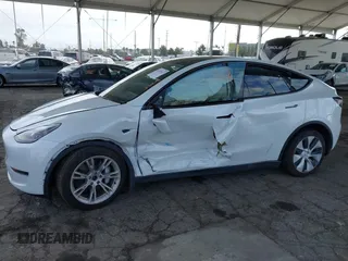 2023 Tesla Model Y Long Range with VIN 7SAYGAEE7PF607195, listed as a IAAI auction lot 41819147 with 74,694 mi miles. Bid and sale history available at carsss.com. Image 6.