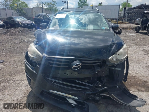 2016 Mazda CX-5 Sport with VIN JM3KE4BY2G0796577, listed as a IAAI auction lot 42230645 with 103,223 mi miles and . Bid and sale history available at DreamBid. Image 6.