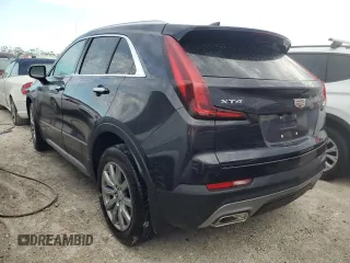2022 Cadillac XT4 FWD Premium Luxury z VIN 1GYFZCR44NF166169, wystawiony jako Copart lot #77981414 z przebiegiem 9 734 mil mil oraz Nie do naprawy • Non repairable. Historia ofert i sprzedaży dostępna na DreamBid. Obrazek 2.