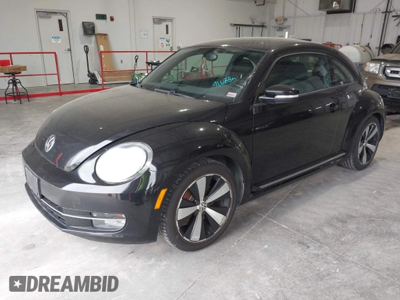 2012 Volkswagen Beetle 2.0T Turbo w/Sun/Snd/Nav PZEV with VIN 3VWVA7AT8CM617830, listed as a IAAI auction lot 42024546 with 91,688 mi miles. Bid and sale history available at carsss.com. Image 2.
