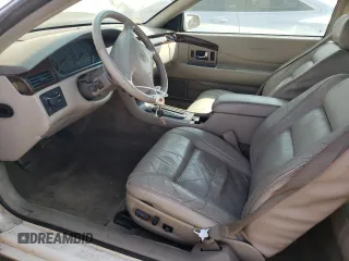 2000 Cadillac Eldorado z VIN 1G6EL12Y2YU179560, wystawiony jako Copart lot #70635784 z przebiegiem 92 959 mil mil oraz Tytuł czysty. Historia ofert i sprzedaży dostępna na DreamBid. Obrazek 7.