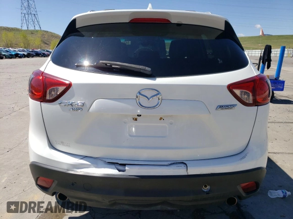 2014 Mazda CX-5 Touring z VIN JM3KE4CYXE0393443, wystawiony jako Copart lot #54738705 z przebiegiem 68 220 mil mil oraz Szkody całkowita. Historia ofert i sprzedaży dostępna na DreamBid. Obrazek 6.