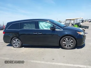 2014 Honda Odyssey Touring with VIN 5FNRL5H99EB133864, listed as a IAAI auction lot 42201359 with 122,490 mi miles and . Bid and sale history available at DreamBid. Image 13.