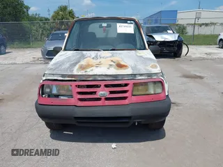 1996 Chevrolet Tracker z VIN 2CNBE1862T6948982, wystawiony jako IAAI lot #42719225 z przebiegiem 257 760 mil mil oraz . Historia ofert i sprzedaży dostępna na DreamBid. Obrazek 6.