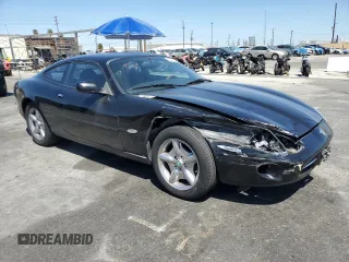 1997 Jaguar XK with VIN SAJGX5740VC014035, listed as a Copart auction lot 53066215 with 140,692 mi miles and Salvage Title. Bid and sale history available at DreamBid. Image 4.