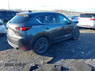 2021 Mazda CX-5 Touring with VIN JM3KFBCM8M1370640, listed as a IAAI auction lot 41207736 with 57,570 mi miles. Bid and sale history available at carsss.com. Image 4.