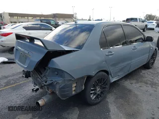 2004 Mitsubishi Lancer ES with VIN JA3AJ26E54U054570, listed as a IAAI auction lot 41592397 with 220,140 mi miles. Bid and sale history available at carsss.com. Image 4.