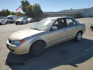 2002 Mazda Protege DX with VIN JM1BJ225521581079, listed as a Copart auction lot 76352594 with 69,405 mi miles and Salvage Title. Bid and sale history available at DreamBid. Image 1.