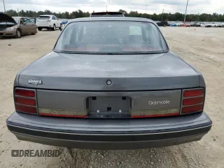 1992 Oldsmobile Cutlass z VIN 1G3AL54N4N6438104, wystawiony jako Copart lot #74415204 z przebiegiem 118 459 mil mil oraz Szkody całkowita. Historia ofert i sprzedaży dostępna na DreamBid. Obrazek 6.