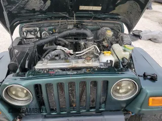2000 Jeep Wrangler Sahara z VIN 1J4FA59S5YP803327, wystawiony jako Copart lot #44382505 z przebiegiem Nie podano mil oraz Szkoda całkowita • Salvage title. Historia ofert i sprzedaży dostępna na DreamBid. Obrazek 13.