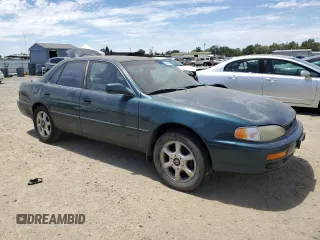 1996 Toyota Camry LE with VIN 4T1BF12K5TU861825, listed as a Copart auction lot 59803174 with 217,650 mi miles and Salvage title. Bid and sale history available at DreamBid. Image 4.