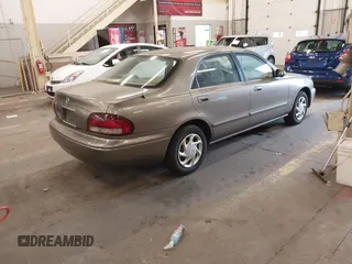 1999 Mazda 626 ES with VIN 1YVGF22C1X5852798, listed as a IAAI auction lot 41736489 with 136,536 mi miles. Bid and sale history available at carsss.com. Image 4.