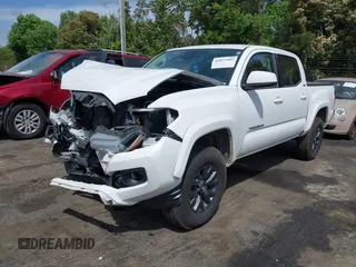2021 Toyota Tacoma SR z VIN 5TFCZ5AN5MX265181, wystawiony jako IAAI lot #42077902 z przebiegiem 102 192 mil mil oraz . Historia ofert i sprzedaży dostępna na DreamBid. Obrazek 2.