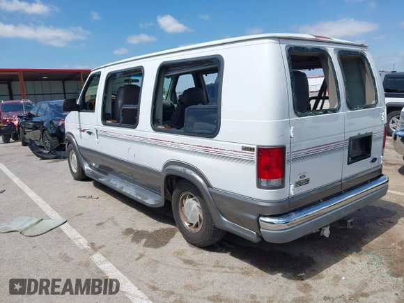 1999 Ford Econoline Cargo Recreational with VIN 1FDRE14L2XHA41059, listed as a IAAI auction lot 42067879 with 149,185 mi miles. Bid and sale history available at carsss.com. Image 3.